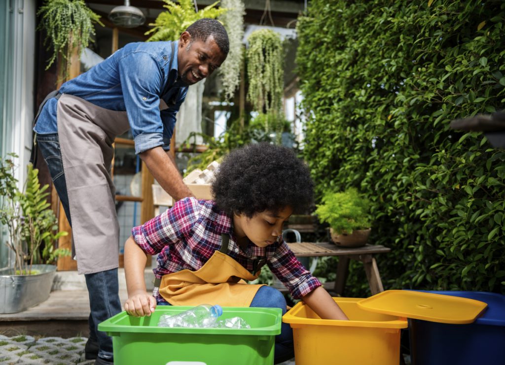 African Descent Kid Separating Recyclable Trash